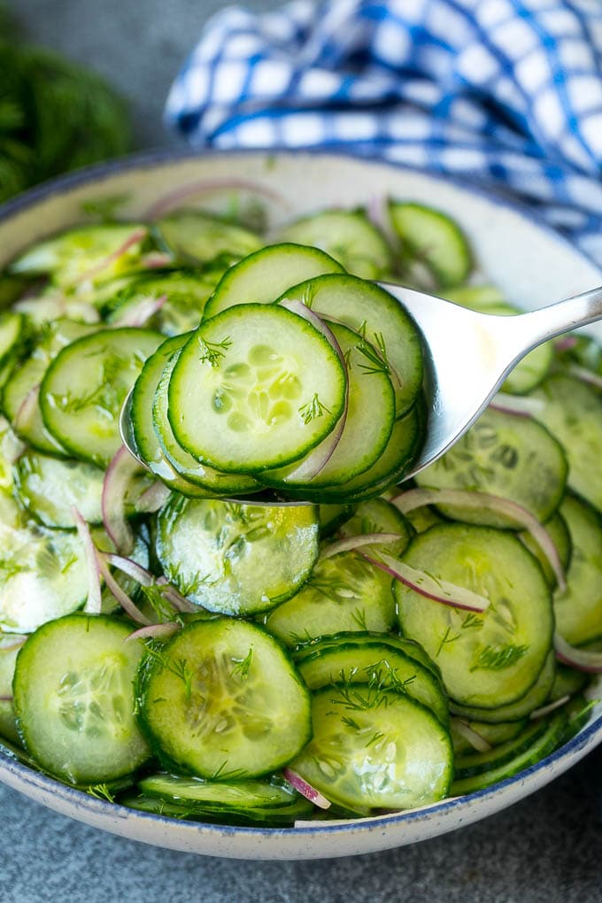 Cucumber Salad Recipe | Cucumber Dill Salad | Cucumber Recipe #cucumbers #salad #glutenfree #sidedish #sraye A spoon serving up a portion of classic cucumber salad.