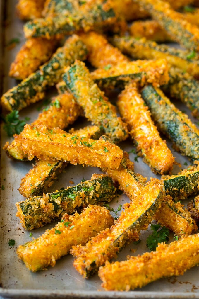 Fried Zucchini Recipe | Zucchini Fries | Zucchini Recipe #appetizer #zucchini #snack #sraye Fried zucchini sticks on a sheet pan.