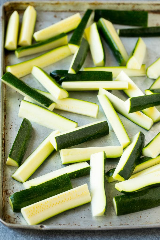 Fried Zucchini Recipe | Zucchini Fries | Zucchini Recipe #appetizer #zucchini #snack #sraye Raw sticks on a sheet pan.