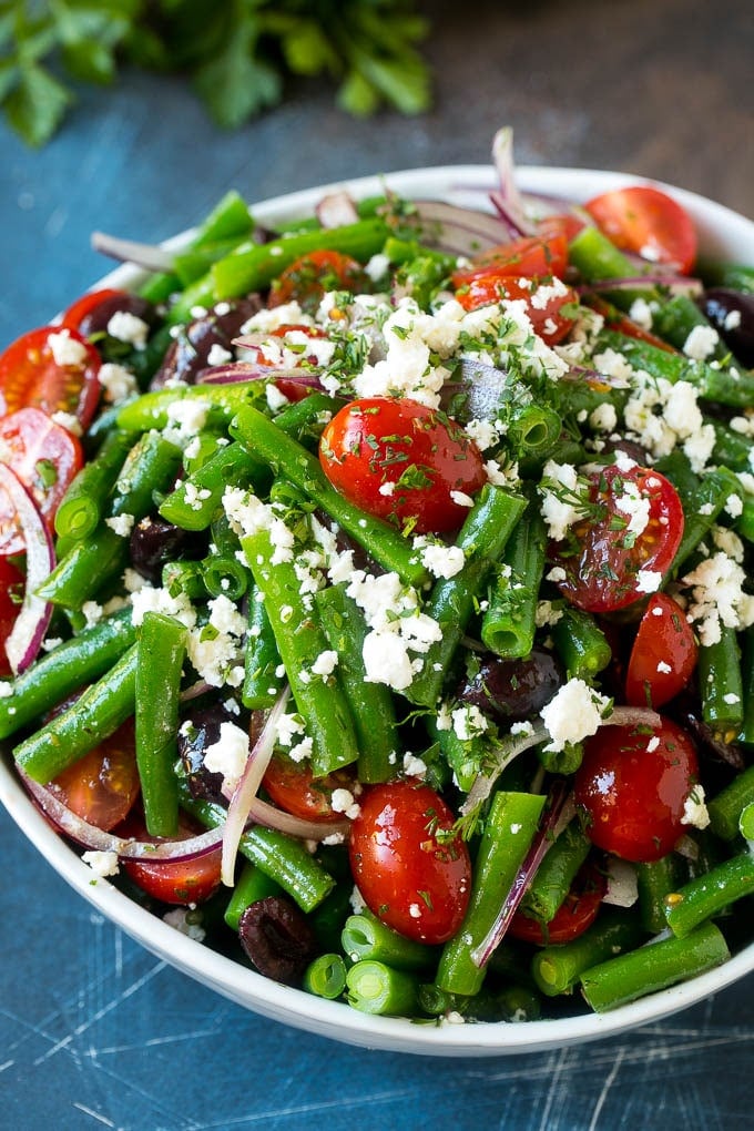 Green Bean Salad Recipe | String Bean Salad | Chopped Salad #greenbeans #tomatoes #olives #salad #cleaneating #lowcarb #glutenfree #sraye A bowl of green bean salad made with feta cheese, tomatoes, red onion and kalamata olives.