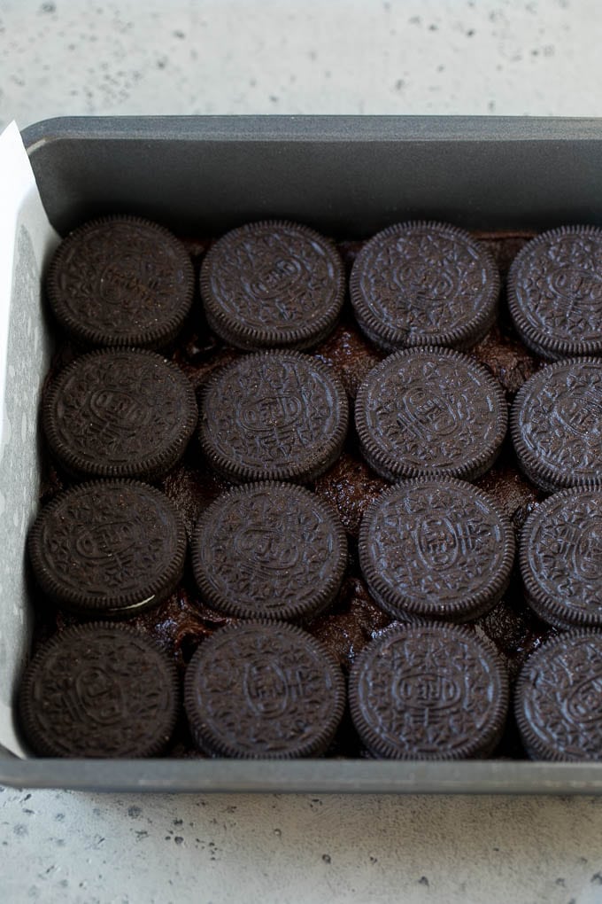 Oreo Brownies Recipe | Homemade Brownies | Chocolate Chip Brownies #brownies #oreos #chocolate #dessert #sweets #sraye A layer of brownie batter with a layer of Oreo cookies on top.