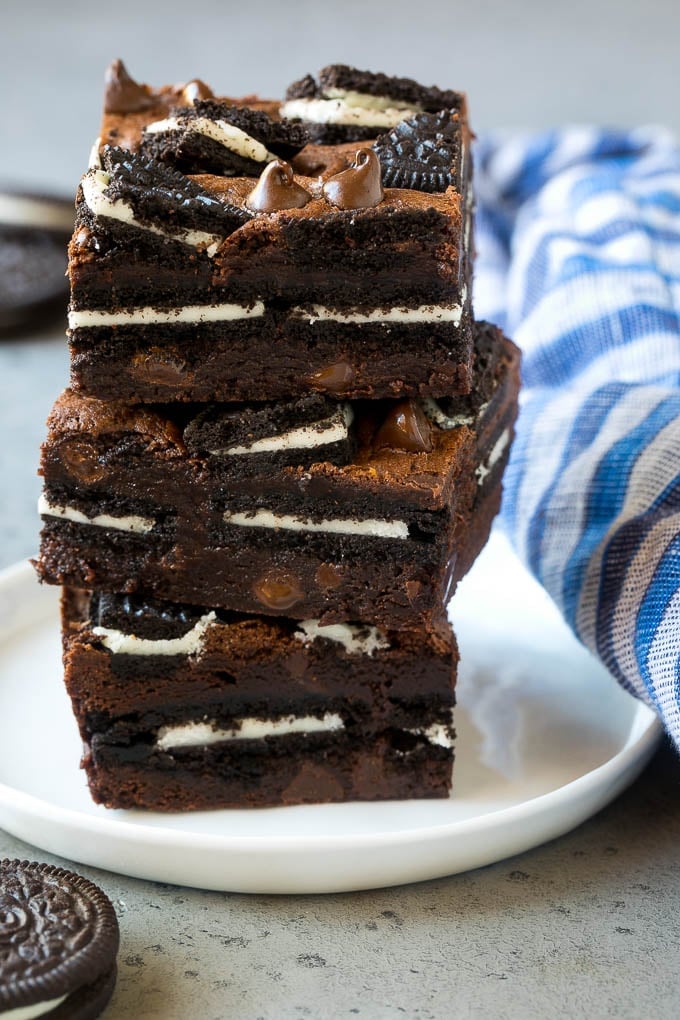 Oreo Brownies Recipe | Homemade Brownies | Chocolate Chip Brownies #brownies #oreos #chocolate #dessert #sweets #sraye A stack of Oreo brownies filled with sandwich cookies and chocolate chips.