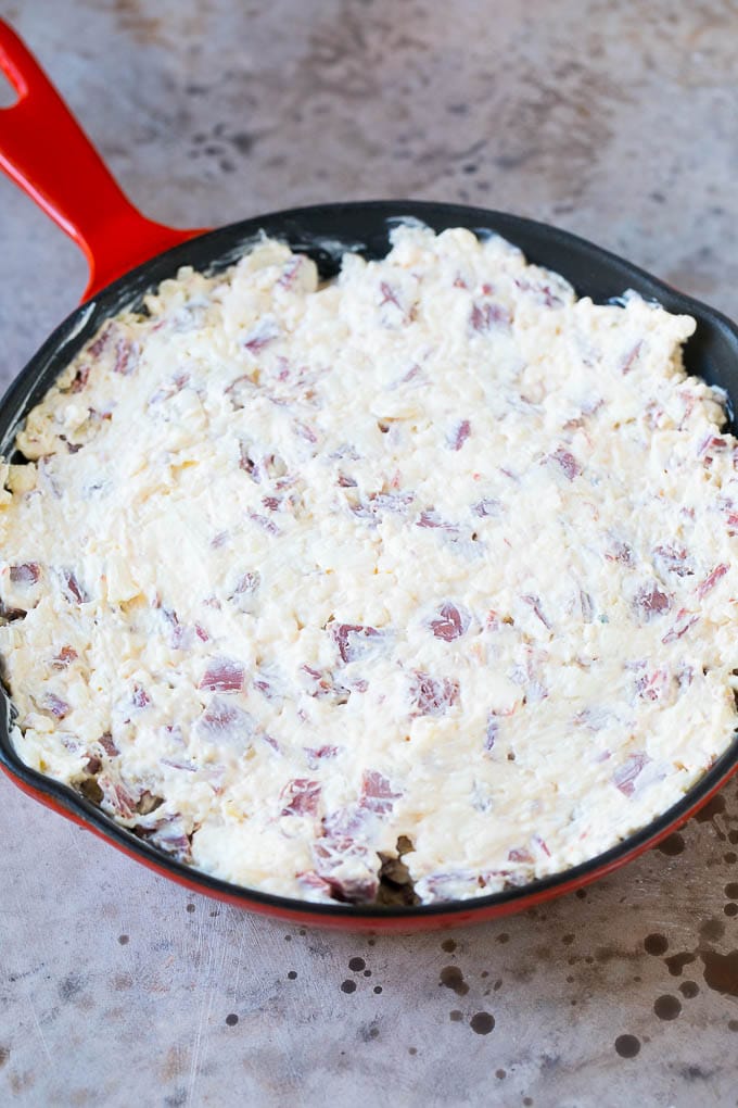 Reuben Dip Recipe | Corned Beef Dip | Cheese Dip #dip #cheese #cornedbeef #appetizer #lowcarb #keto #sraye Cream cheese, corned beef and other ingredients spread into a skillet for baking.
