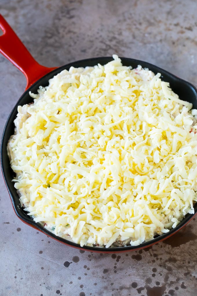 Reuben Dip Recipe | Corned Beef Dip | Cheese Dip #dip #cheese #cornedbeef #appetizer #lowcarb #keto #sraye A skillet of dip topped with shredded cheese.