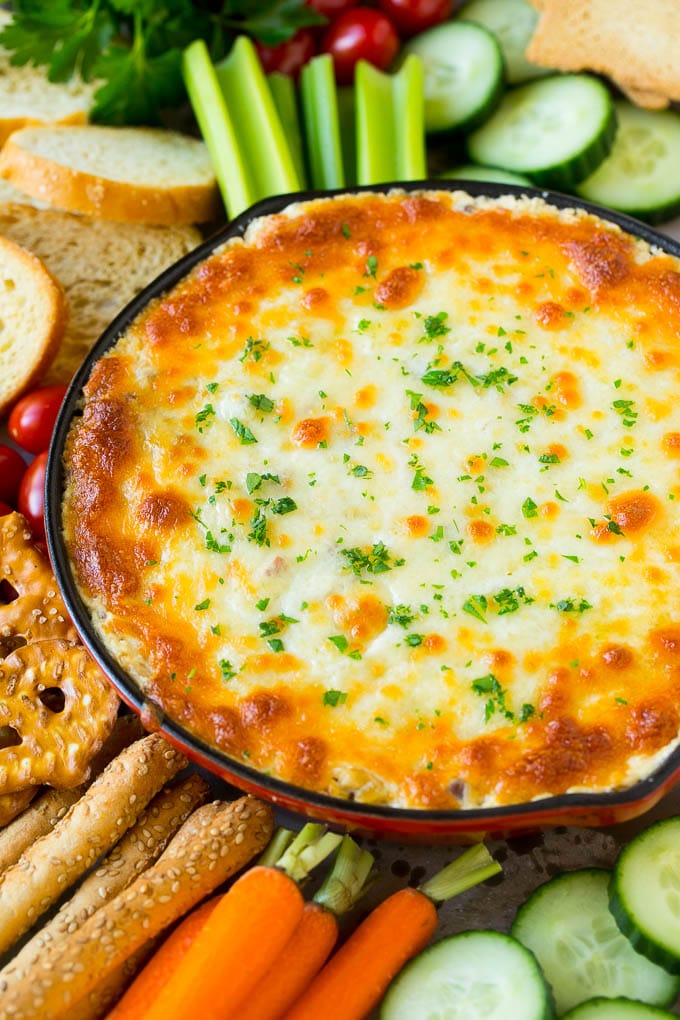 Reuben Dip Recipe | Corned Beef Dip | Cheese Dip #dip #cheese #cornedbeef #appetizer #lowcarb #keto #sraye Baked Reuben dip in a skillet served with crackers and vegetables.