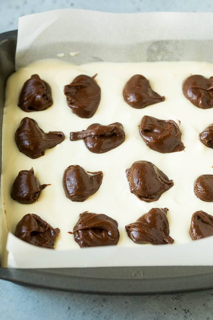 Cheesecake Brownies Recipe | Cream Cheese Brownies | Homemade Brownies #brownies #cheesecake #chocolate #dessert #sraye Brownies topped with a layer of cheesecake and dollops of chocolate batter.