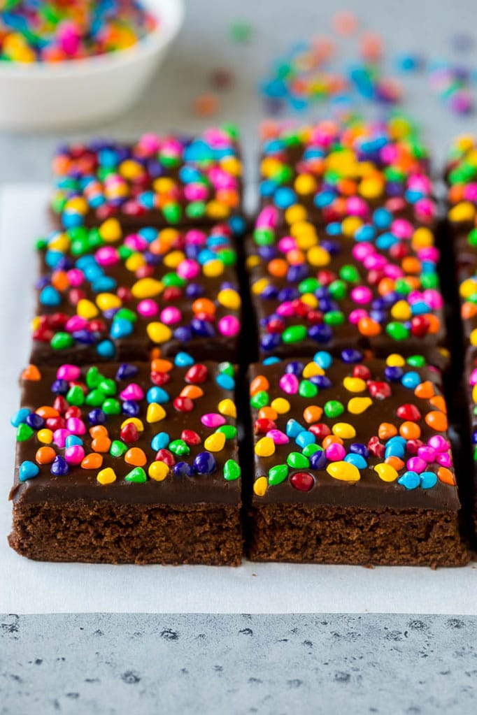 Cosmic Brownies Recipe | Cocoa Brownies | Frosted Brownies #brownies #chocolate #dessert #sraye #sprinkles Cosmic brownies topped with chocolate fudge and crunchy rainbow sprinkles.