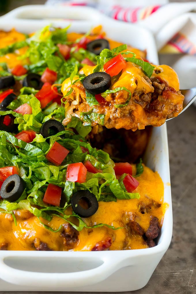 Taco Casserole Recipe | Mexican Casserole | Beef Casserole #casserole #tacos #beef #dinner #cheese #sraye A spoon serving up a portion of beef taco casserole.