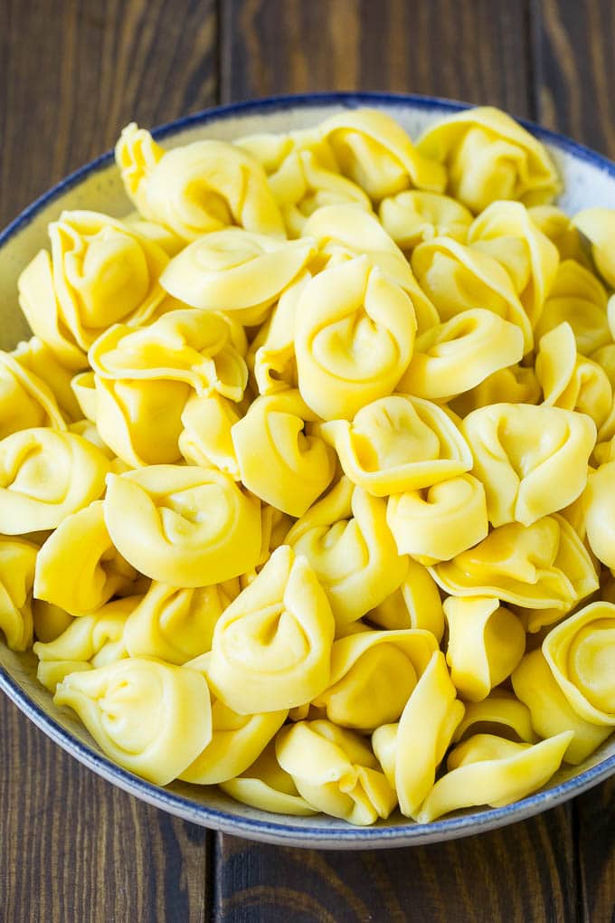 Greek Tortellini Salad Recipe | Pasta Salad | Tortellini Salad | Greek Salad #greek #tortellini #pasta #salad #cucumbers #olives #dinner #sraye A bowl of cooked cheese tortellini.