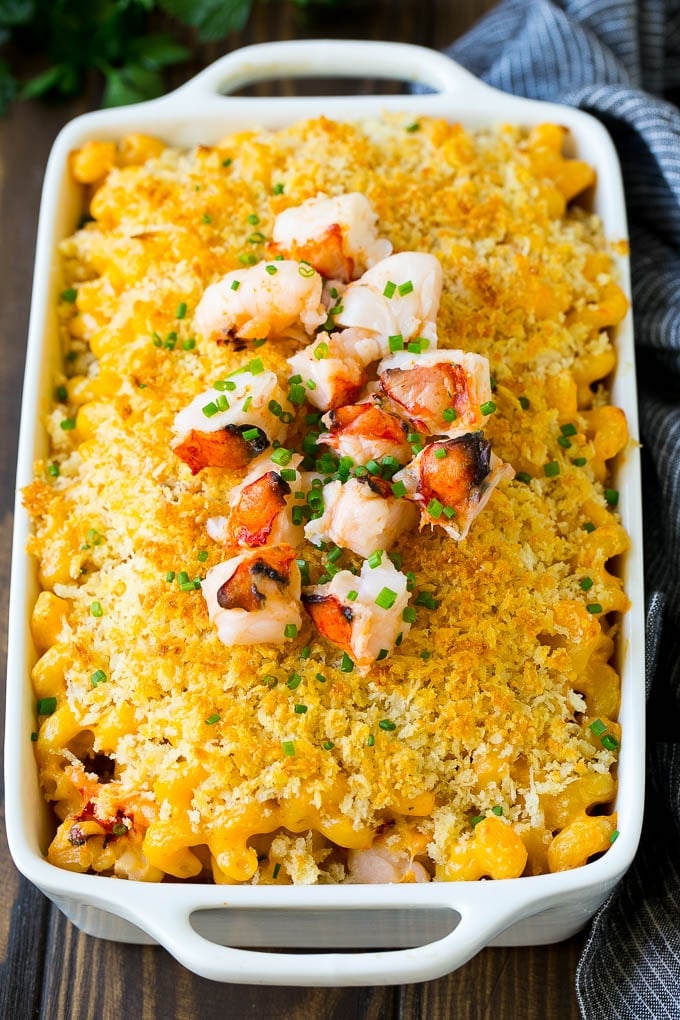 Lobster Mac and Cheese Recipe | Lobster Macaroni and Cheese | Baked Mac and Cheese #pasta #macandcheese #macaroni #lobster #cheese #dinner #sraye A baking dish of lobster macaroni and cheese, garnished with chopped lobster meat.