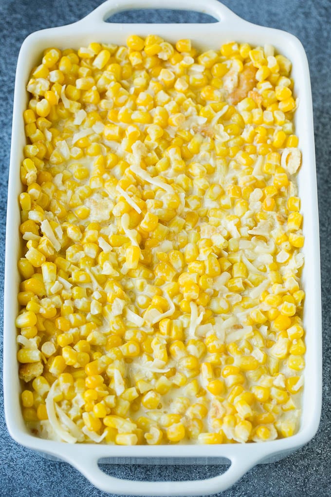 Scalloped Corn | Corn Casserole #corn #casserole #cheese #sidedish #dinner #sraye A baking pan of corn in a creamy custard mixture.