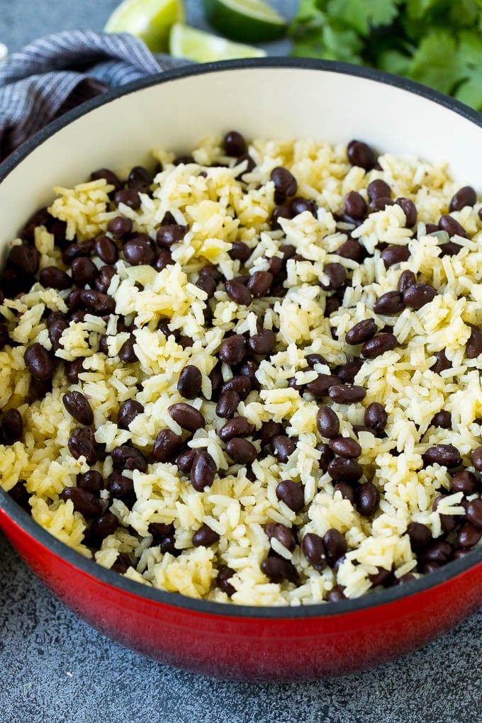 Black Beans and Rice Recipe | Cuban Black Beans | Beans and Rice #beans #rice #blackbeans #sidedish #glutenfree #dinner #sraye Rice and beans mixed together in a red pot.