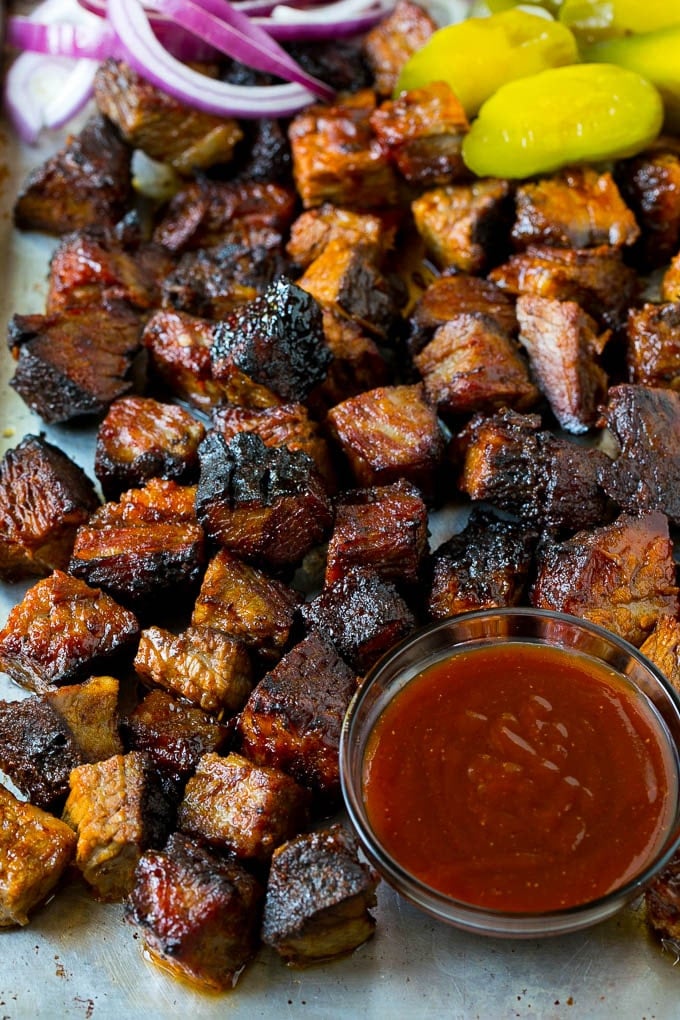 Burnt Ends Recipe | Smoked Brisket | Beef Brisket #brisket #bbq #smoker #beef #dinner #sraye Burnt ends on a sheet pan served with BBQ sauce, red onions and pickles.