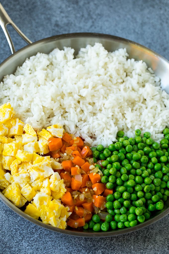 Chicken Fried Rice Recipe | Chinese Fried Rice #rice #chicken #peas #carrots #sidedish #dinner #sraye A pan of cooked rice, carrots, eggs and peas.