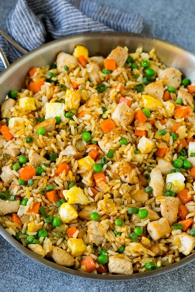 Chicken Fried Rice Recipe | Chinese Fried Rice #rice #chicken #peas #carrots #sidedish #dinner #sraye A pan of chicken fried rice with eggs and vegetables.