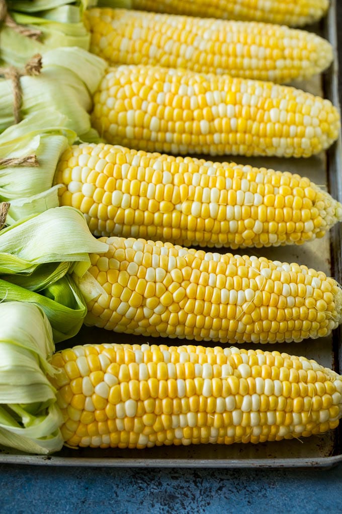 Grilled Corn on the Cob Recipe | Corn Recipe #corn #grilling #summer #sidedish #dinner #sraye Corn cobs on a sheet pan.