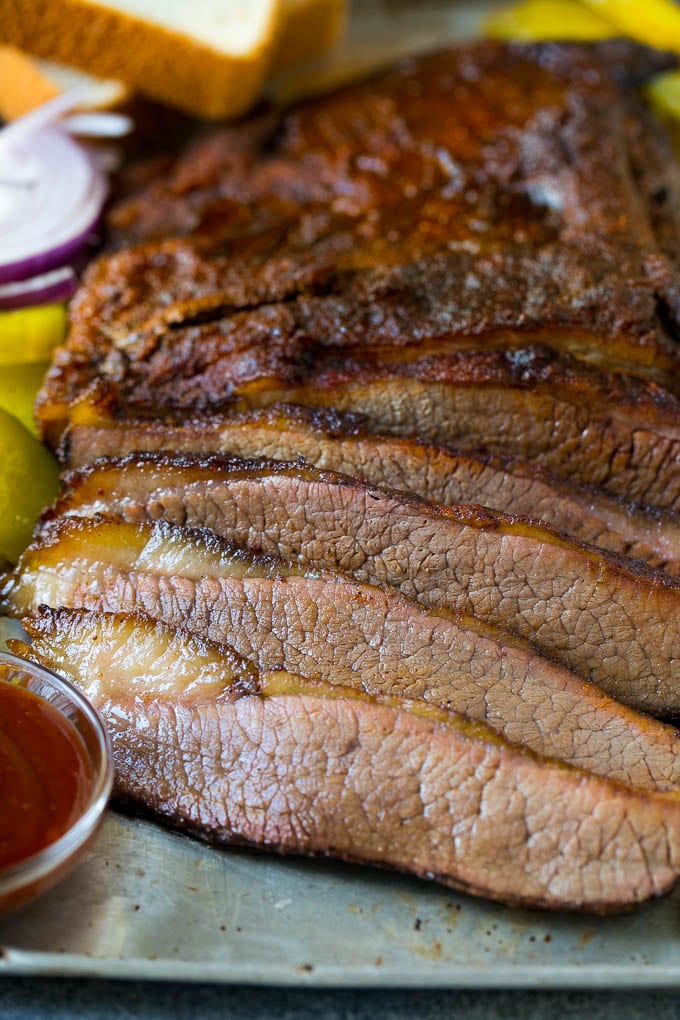 Smoked Brisket Recipe | Beef Brisket | BBQ Beef #brisket #smoker #beef #bbq #dinner #sraye Sliced smoked brisket with a side of BBQ sauce.