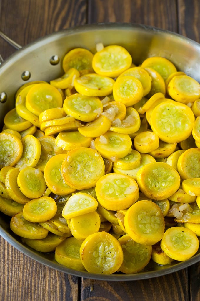 Squash Casserole Recipe | Vegetable Casserole | Zucchini Casserole #casserole #squash #zucchini #cheese #sidedish #sraye Yellow squash and onions in a frying pan.