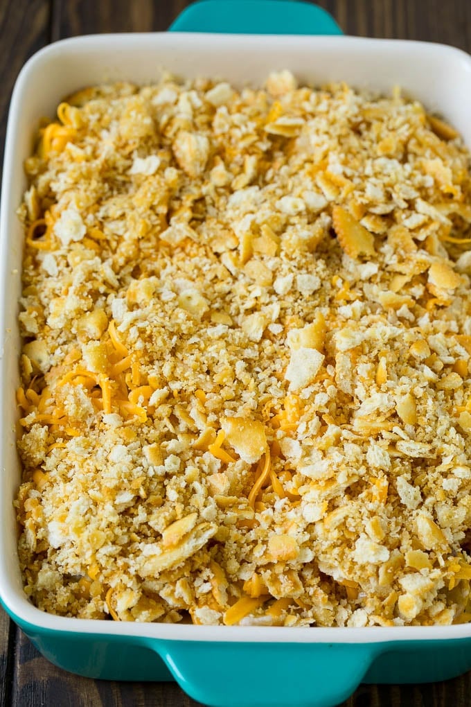 Squash Casserole Recipe | Vegetable Casserole | Zucchini Casserole #casserole #squash #zucchini #cheese #sidedish #sraye Squash in a baking dish topped with cracker crumbs and cheddar cheese.