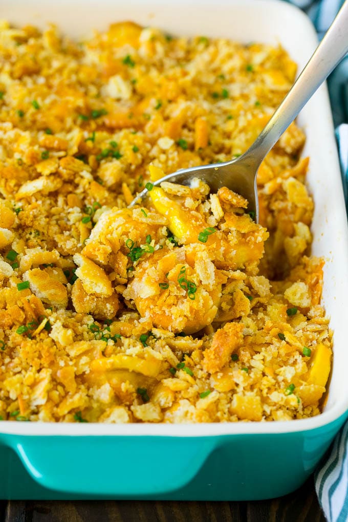 Squash Casserole Recipe | Vegetable Casserole | Zucchini Casserole #casserole #squash #zucchini #cheese #sidedish #sraye A serving spoon in a dish of squash casserole.