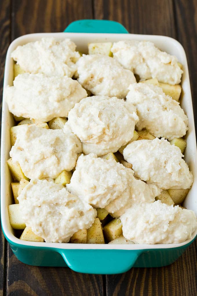 Apple Cobbler Recipe | Apple Dessert #apples #cobbler #dessert #baking #fall #sraye Fruit in a baking dish with dough over the top.