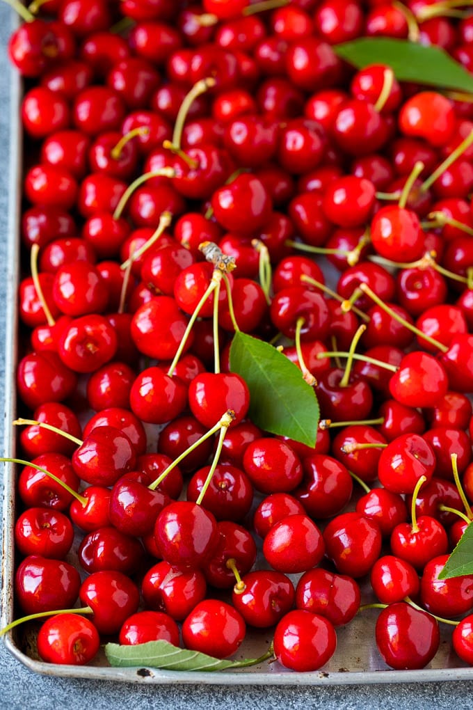Cherry Pie Filling Recipe #pie #cherries #dessert #sweets #sraye #summer Fresh cherries spread out on a sheet pan.
