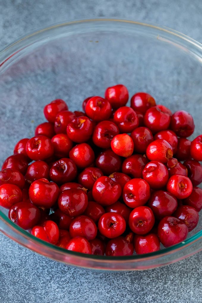 Cherry Pie Filling Recipe #pie #cherries #dessert #sweets #sraye #summer A bowl of pitted cherries.