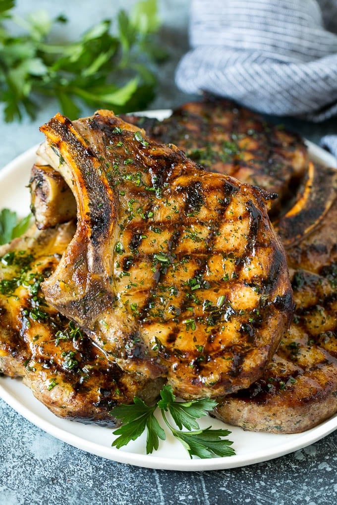 Grilled Pork Chops | Pork Chop Marinade #porkchops #grilling #pork #marinade #dinner #sraye Grilled pork chops coated in marinade then cooked and garnished with parsley.