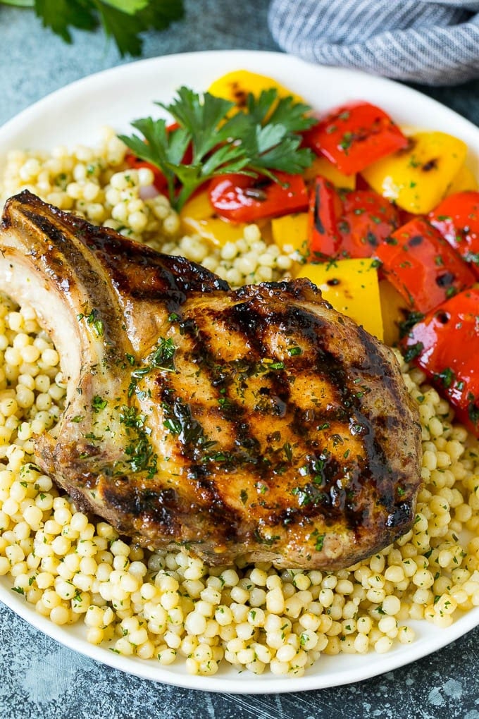 Grilled Pork Chops | Pork Chop Marinade #porkchops #grilling #pork #marinade #dinner #sraye A grilled pork chop served over couscous with bell peppers on the side.