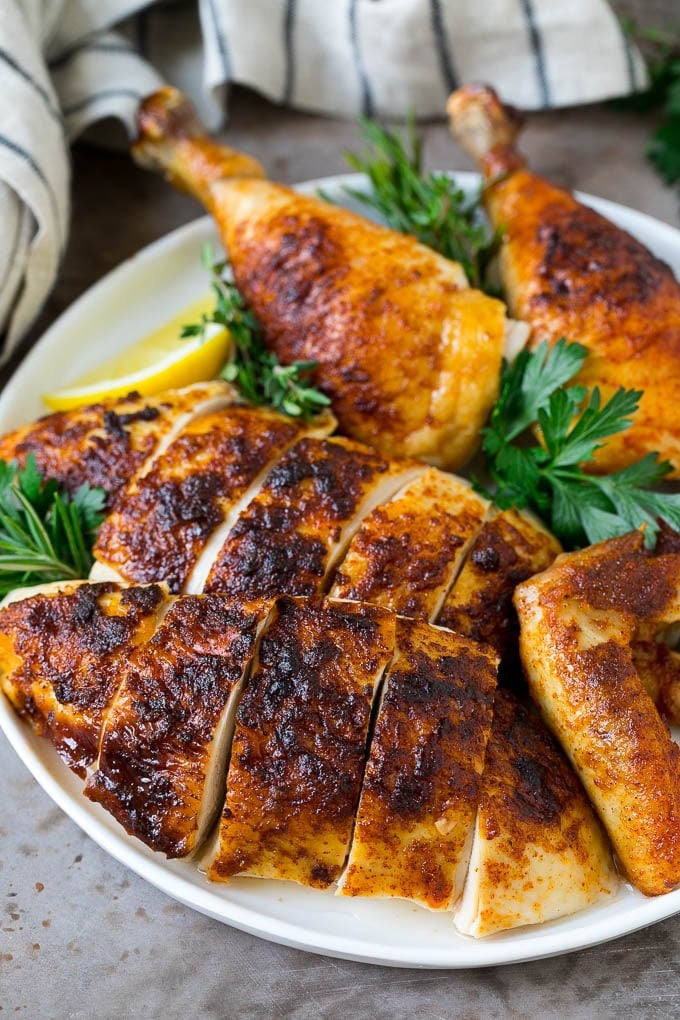 Rotisserie Chicken Recipe | Roasted Chicken #chicken #dinner #sraye #comfortfood Sliced roasted chicken on a serving plate.