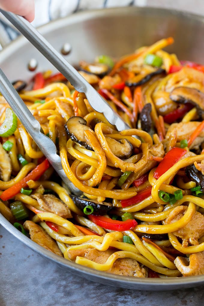 Stir Fry Noodles Recipe | Noodle Stir Fry #chicken #noodles #stirfry #mushrooms #dinner #sraye Tongs serving up a portion of chicken and noodle stir fry.