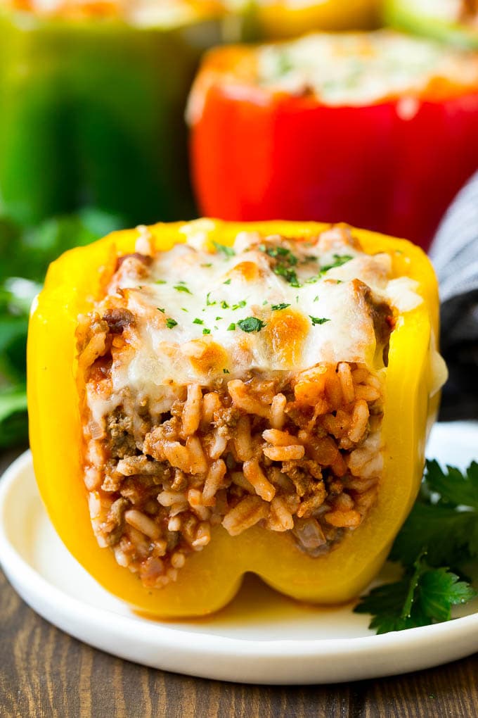 Stuffed Bell Peppers Recipe | Stuffed Peppers #beef #rice #peppers #dinner #cheese #sraye A stuffed bell pepper cut open on a plate.