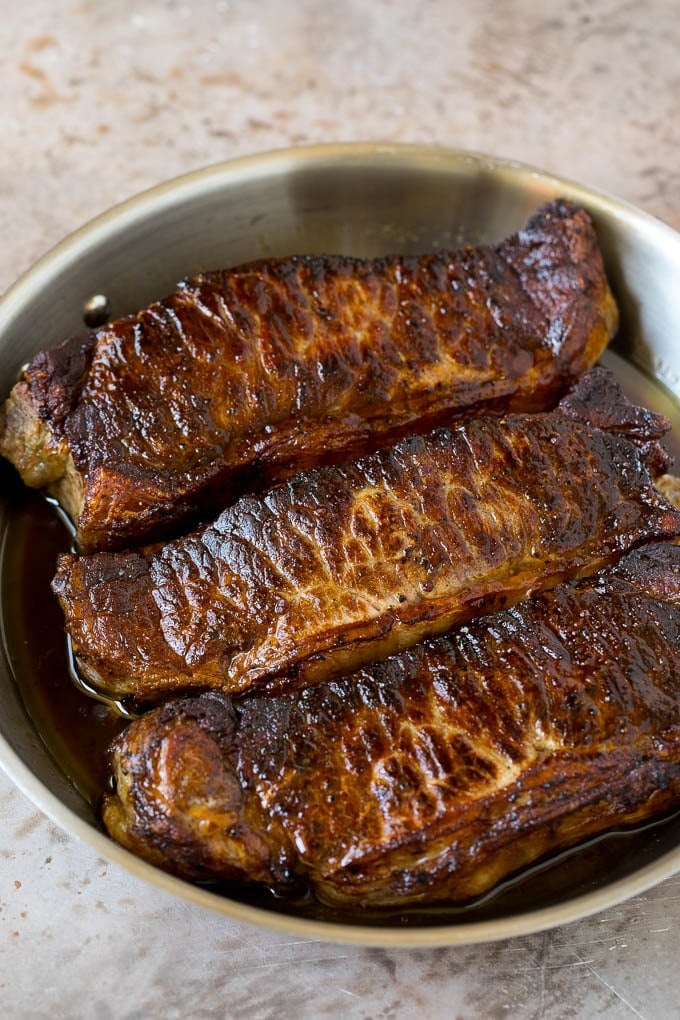 Surf and Turf Recipe | Seared Steak #steak #shrimp #keto #lowcarb #dinner #sraye Seared strip steaks in a skillet.