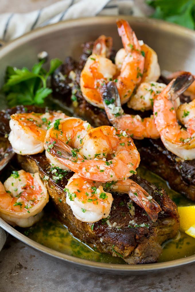 Surf and Turf Recipe | Seared Steak #steak #shrimp #keto #lowcarb #dinner #sraye Surf and turf with seared strip steaks topped with jumbo shrimp in garlic butter.