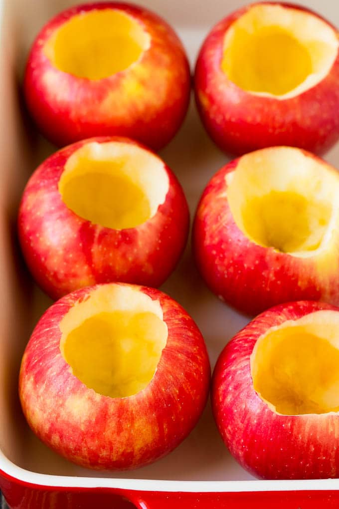 Baked Apples | Stuffed Apples #apples #fall #dessert #sweettooth #sraye Hollowed out apples in a baking dish.
