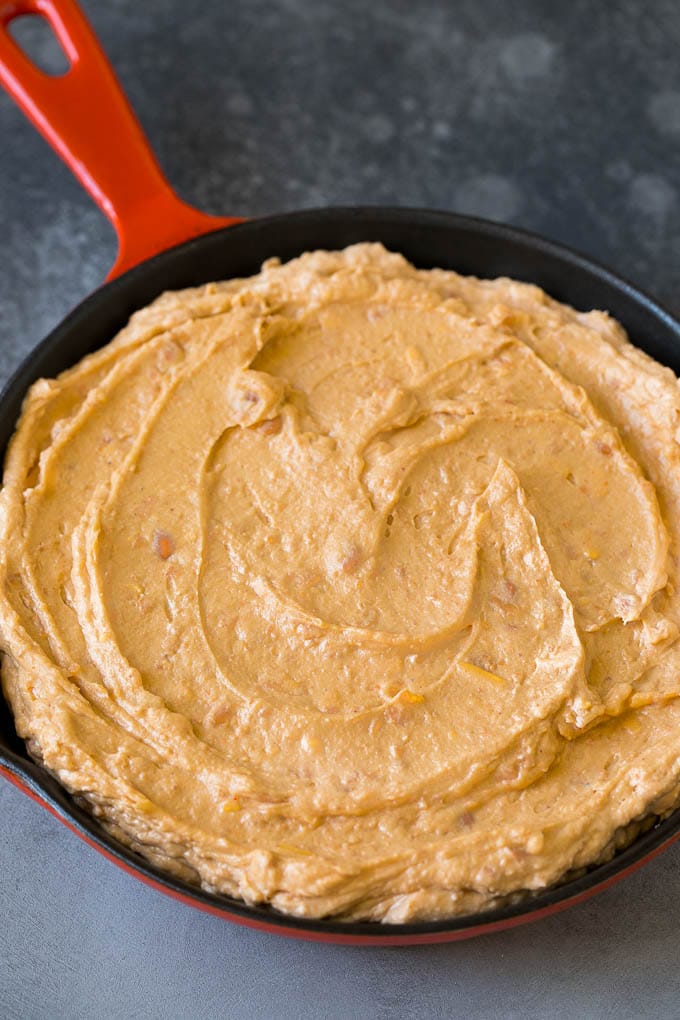 Bean Dip Recipe | Mexican Dip #dip #appetizer #mexicanfood #beans #cheese #sraye Refried frijoles mixed with cream cheese, sour cream and seasonings in a skillet.