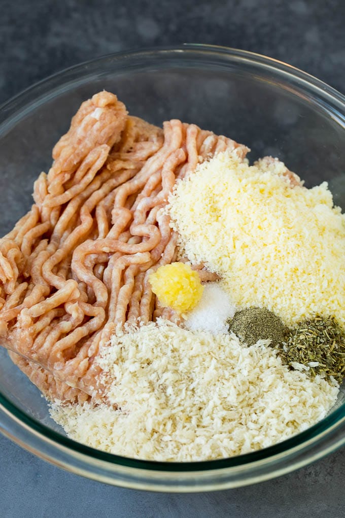 Chicken Meatballs Recipe | Baked Meatballs #chicken #meatballs #dinner #sraye #comfortfood Ground chicken, herbs, breadcrumbs and cheese in a mixing bowl.