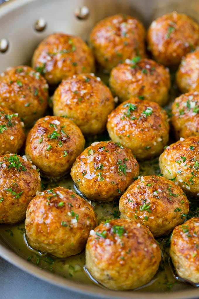 Chicken Meatballs Recipe | Baked Meatballs #chicken #meatballs #dinner #sraye #comfortfood Chicken meatballs in a skillet of garlic butter.