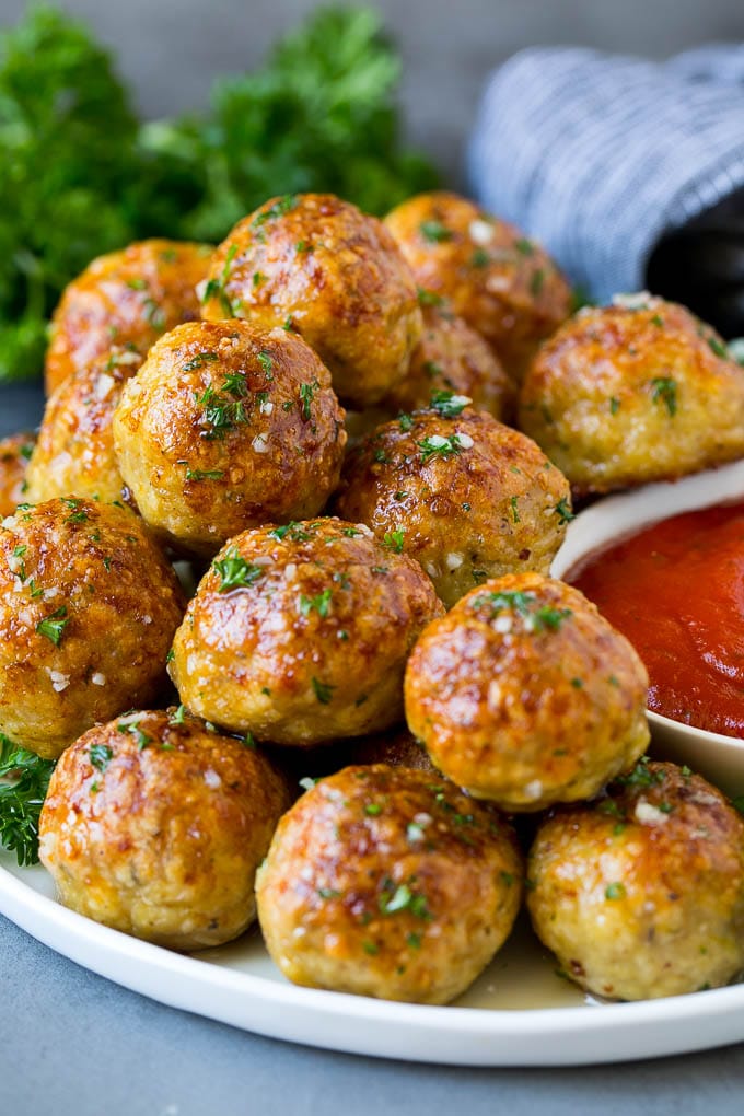 Chicken Meatballs Recipe | Baked Meatballs #chicken #meatballs #dinner #sraye #comfortfood A serving plate of chicken meatballs served with marinara sauce.