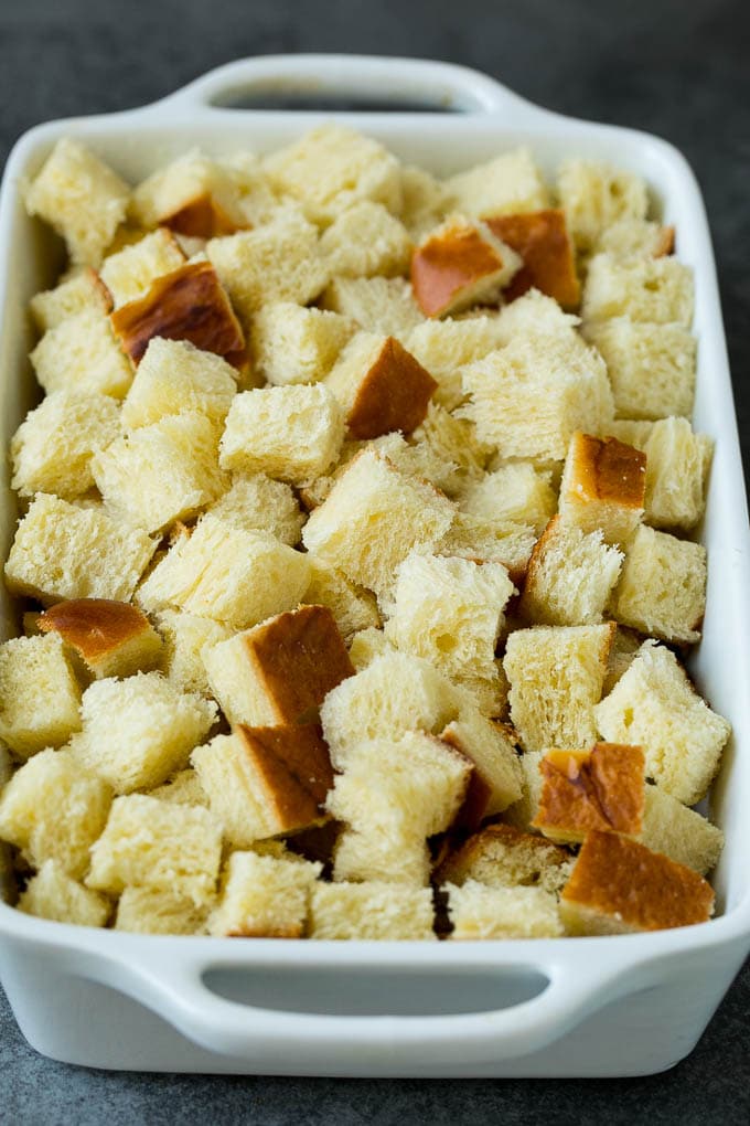 French Toast Casserole Recipe | French Toast Bake #frenchtoast #casserole #breakfast #brunch #sraye #bread Cubes of bread in a baking dish.