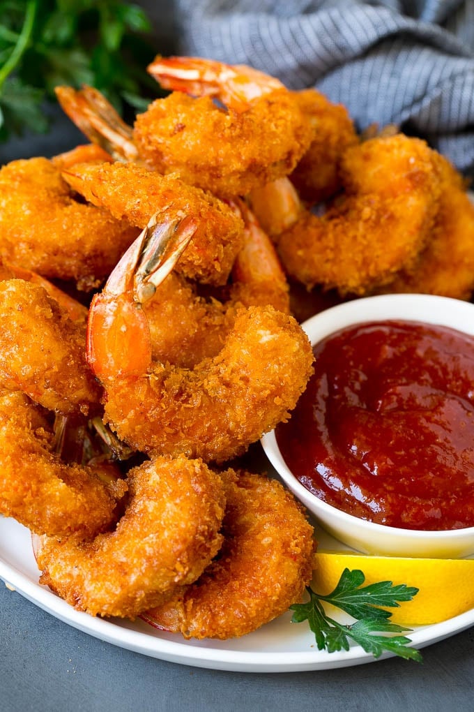 Fried Shrimp Recipe #shrimp #seafood #dinner #appetizer #sraye A plate of fried shrimp served with cocktail sauce.