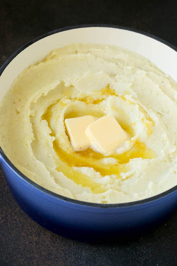 Garlic Mashed Potatoes Recipe #garlic #potatoes #mashedpotatoes #sidedish #dinner #thanksgiving #sraye Spuds with melted butter on top.
