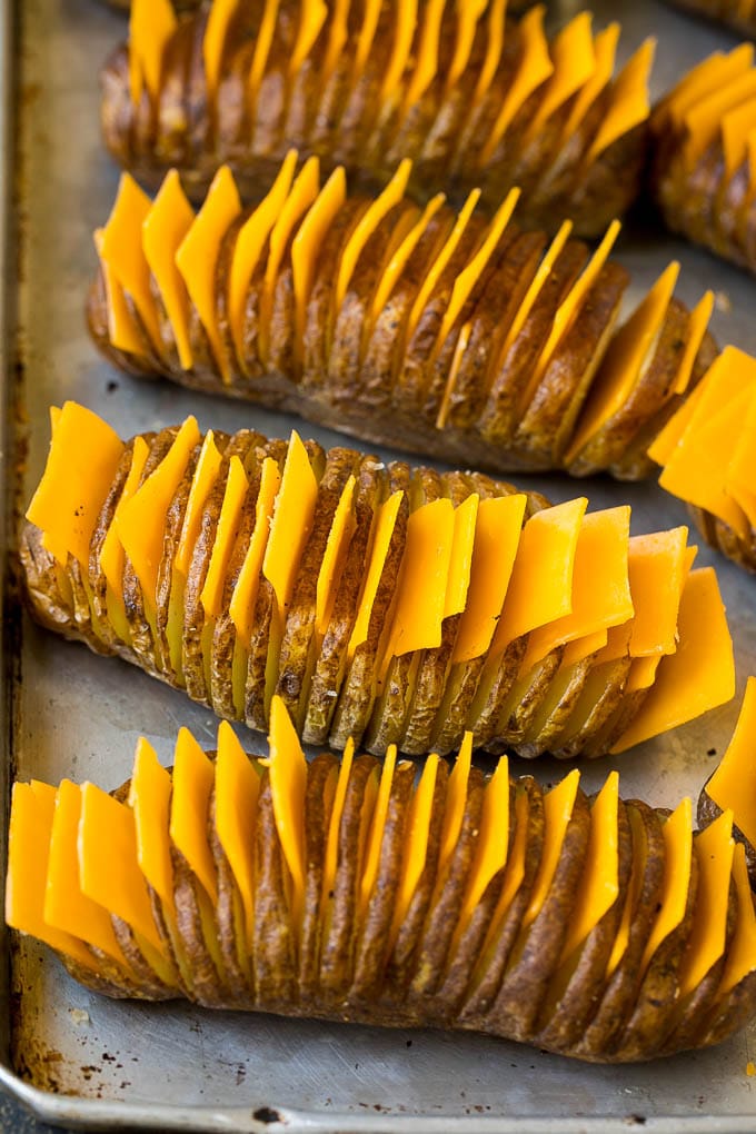 Hasselback Potatoes Recipe #potatoes #bacon #sidedish #cheese #dinner #sraye Thinly sliced potatoes with slices of cheese in between the cuts.