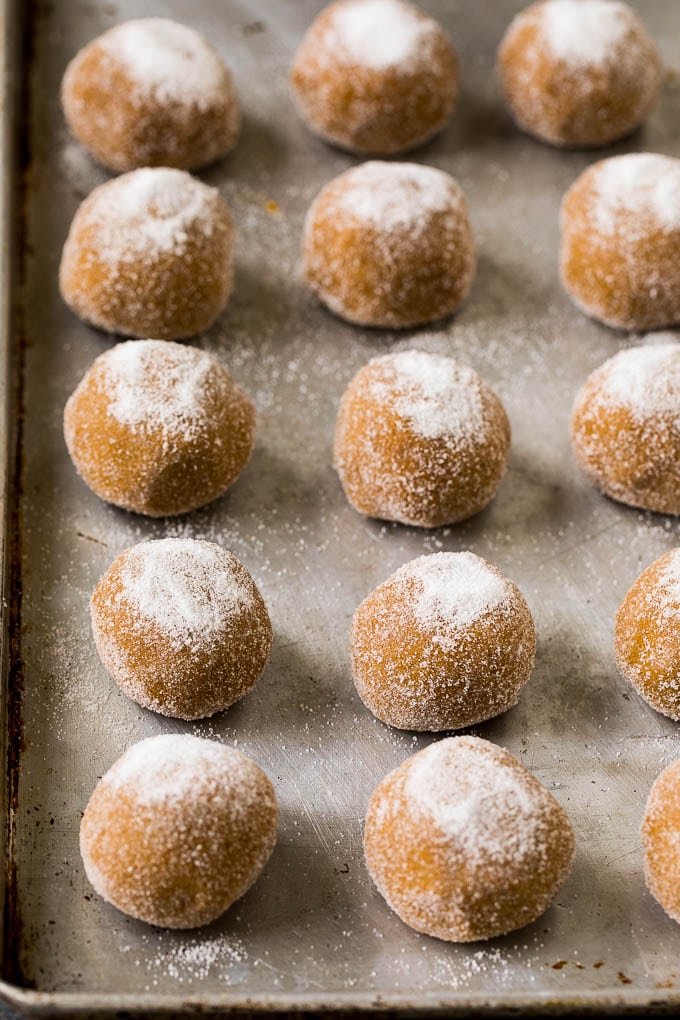 Molasses Cookies Recipe | Spice Cookies #cookies #baking #christmas #dessert #sraye Balls of cookie dough rolled in sugar on a sheet pan.