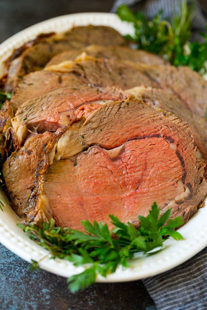Prime Rib Recipe #primerib #beef #roast #dinner #thanksgiving #christmas #keto #lowcarb #sraye Sliced slow roasted prime beef on a serving platter.
