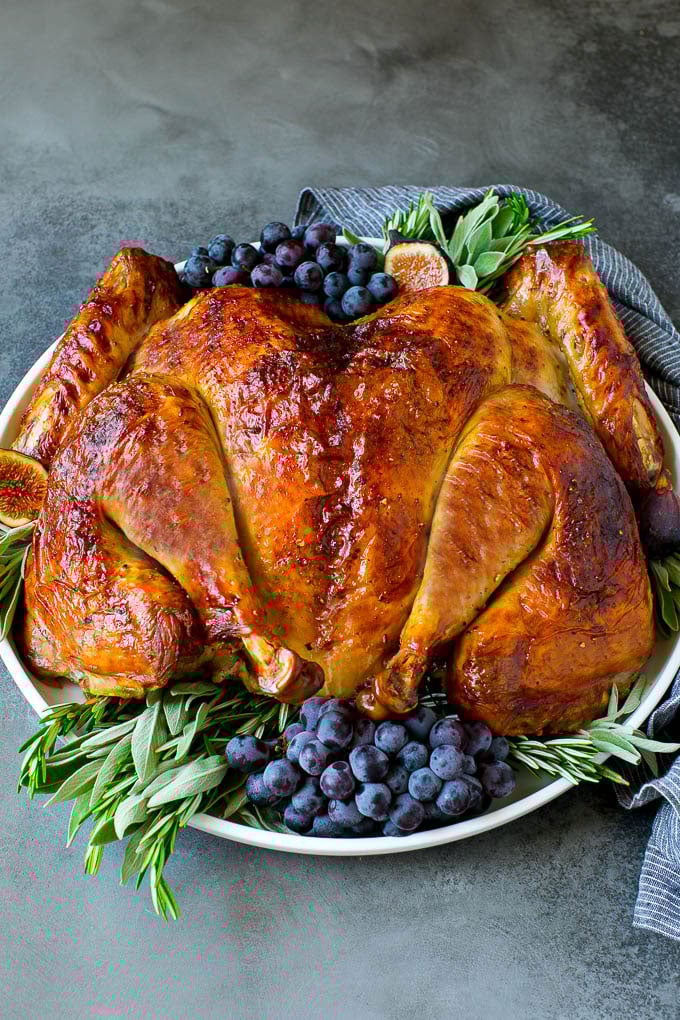 Spatchcock Turkey | Roasted Turkey | Thanksgiving Turkey #turkey #thanksgiving #dinner #fall #christmas #sraye Spatchcock turkey garnished with grapes and fresh herbs.