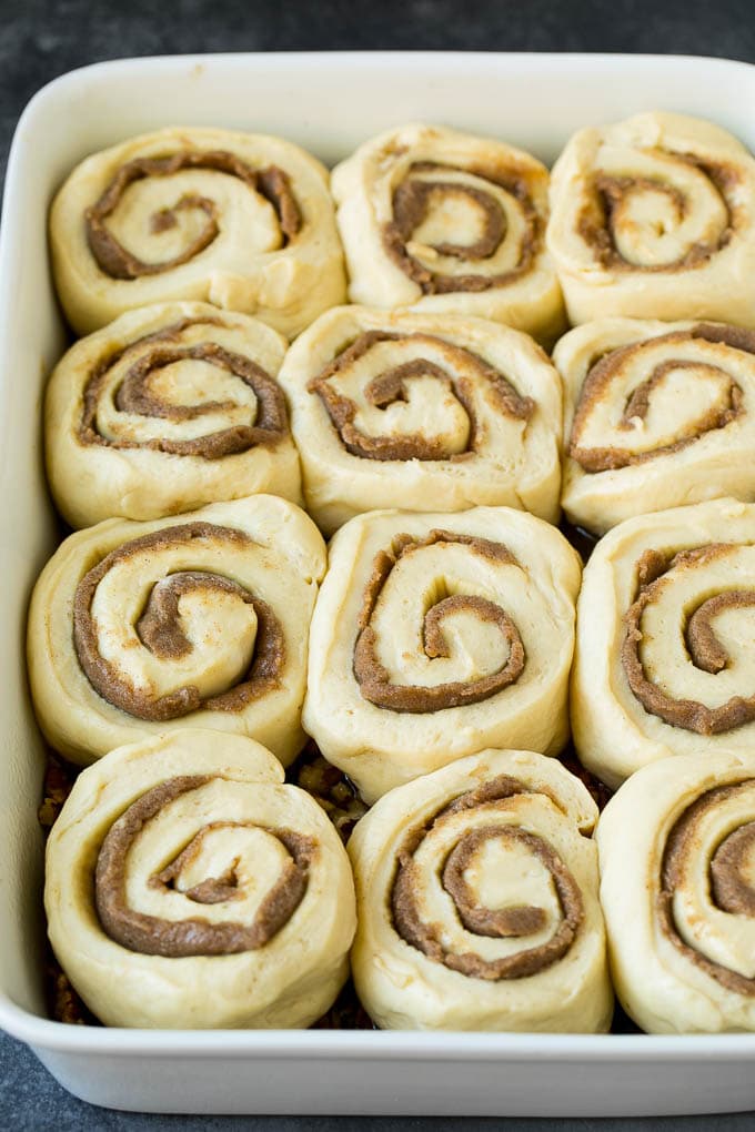 Sticky Buns Recipe | Sweet Rolls | Cinnamon Rolls #breakfast #brunch #cinnamon #pecans #sraye #bread Cinnamon swirl dough in a baking dish.