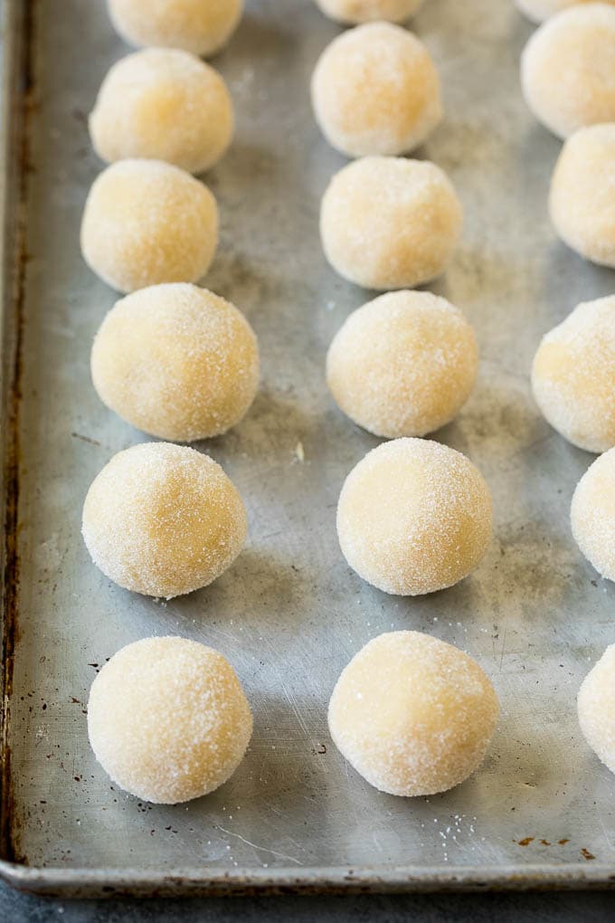 Thumbprint Cookies | Sugar Cookies #cookies #baking #christmas #dessert #sraye Balls of cookie dough rolled in sugar.
