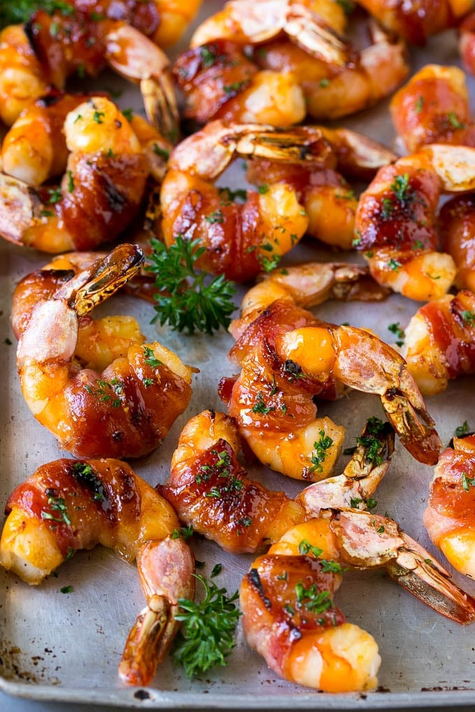Bacon Wrapped Shrimp Recipe | Bacon Shrimp #shrimp #bacon #appetizer #dinner #sraye #seafood Bacon wrapped shrimp in a sweet and savory glaze, garnished with parsley.
