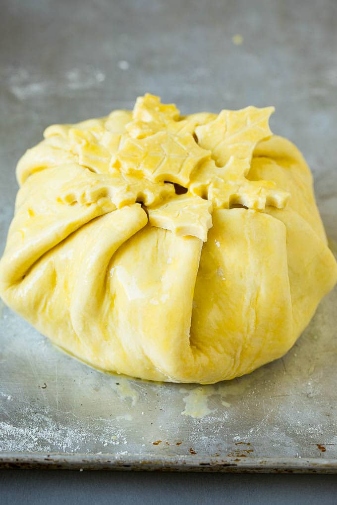 Baked Brie Recipe | Pastry Wrapped Brie #brie #cheese #appetizer #pecans #raspberries #sraye Cheese wrapped in puff pastry and topped with egg wash.